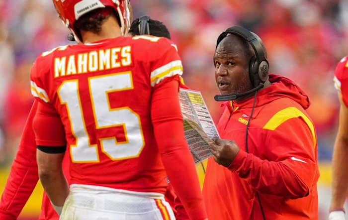 Kansas City Chiefs offensive coordinator Eric Bieniemy talks with quarterback Patrick Mahomes (15) during the second half against the Buffalo Bills at GEHA Field at Arrowhead Stadium.